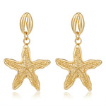 Boucles d'oreilles Coquillage Cauri et étoile de mer dorées
